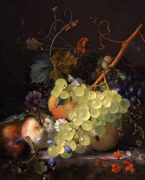 of grapes and a peach on a table top